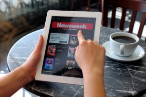 Person reading Newsweek on an ipad